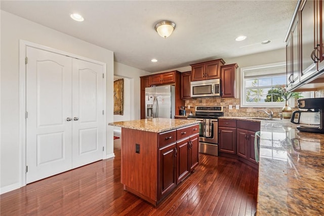 517 Callie Ct, Rostraver, PA 15089 - kitchen with stainless steel appliances, dark wood-type flooring, a center island, light stone counters, and recessed lighting
