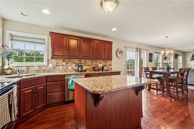 517 Callie Ct, Rostraver, PA 15089 - kitchen with stainless steel dishwasher, dark wood-type flooring, a kitchen island, a chandelier, and backsplash