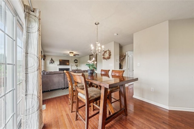 517 Callie Ct, Rostraver, PA 15089 - dining area featuring wood finished floors, a chandelier, and a fireplace