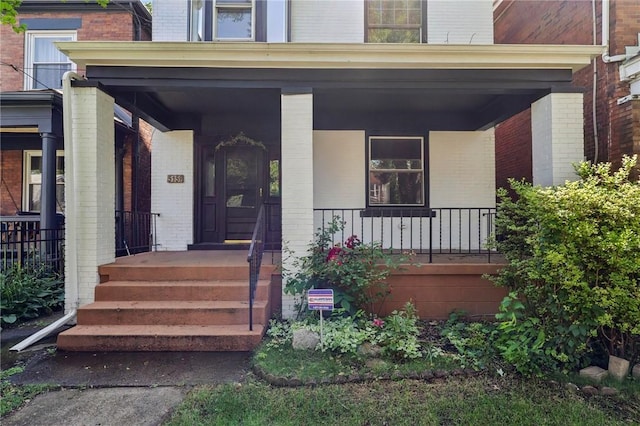 515 Peebles St, Wilkinsburg, PA 15221 - doorway to property with brick siding and a porch