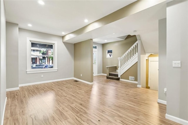 515 Peebles St, Wilkinsburg, PA 15221 - unfurnished living room with light wood-type flooring, stairway, and recessed lighting