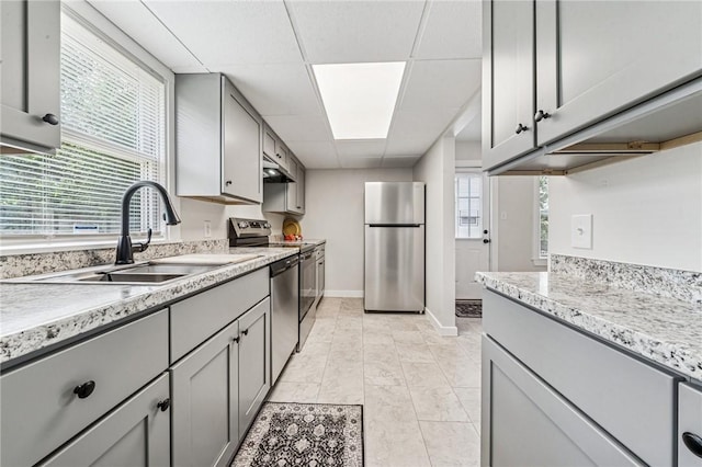 604 N 4th St, Jeannette, PA 15644 - kitchen featuring stainless steel appliances, gray cabinets, a paneled ceiling, under cabinet range hood, and light stone countertops