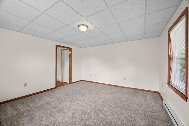 26-28 Clopper St, Sewickley Twp, PA 15637 - carpeted empty room with a baseboard heating unit, a drop ceiling, and healthy amount of natural light