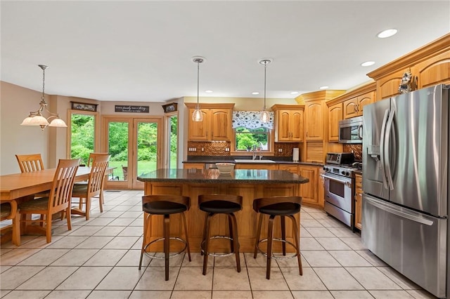 94 Troutman Rd, Pa, PA 16148 - kitchen featuring appliances with stainless steel finishes, a center island, decorative backsplash, light tile patterned floors, and recessed lighting