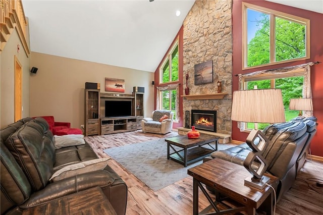 94 Troutman Rd, Pa, PA 16148 - living area featuring high vaulted ceiling, wood finished floors, and a stone fireplace