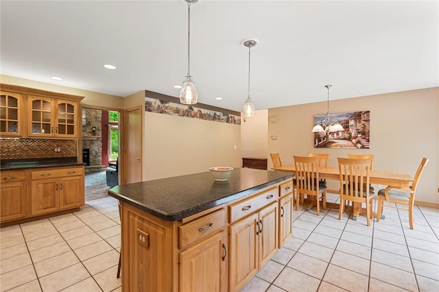 94 Troutman Rd, Pa, PA 16148 - kitchen with light tile patterned floors, dark countertops, glass insert cabinets, decorative backsplash, and recessed lighting