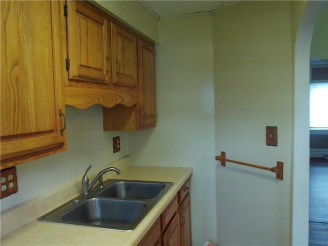 129-131 4th Ave, Scottdale, PA 15683 - kitchen with brown cabinets, light countertops, and arched walkways
