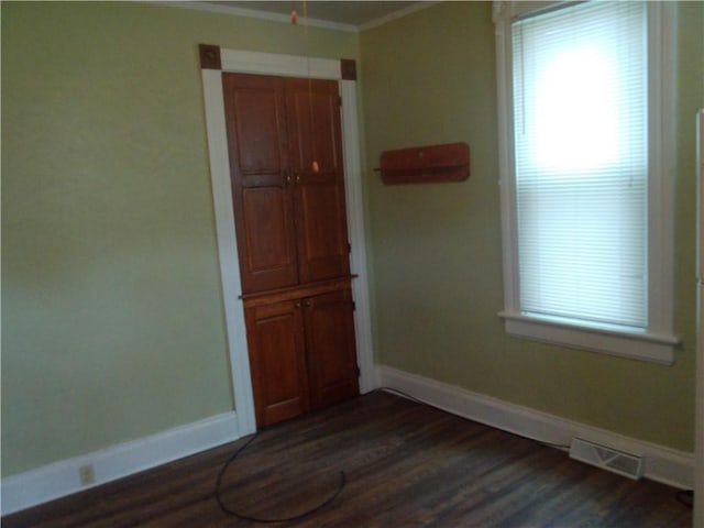 129-131 4th Ave, Scottdale, PA 15683 - empty room with dark wood-type flooring, plenty of natural light, and ornamental molding