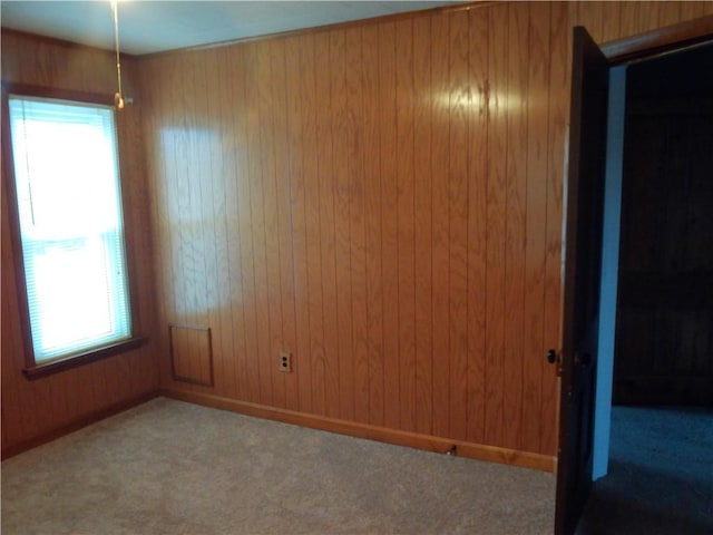 129-131 4th Ave, Scottdale, PA 15683 - carpeted empty room featuring healthy amount of natural light and wood walls
