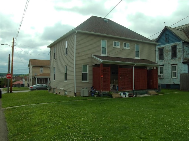 129-131 4th Ave, Scottdale, PA 15683 - back of property with covered porch, a yard, and cooling unit