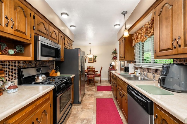 220 N Dr, Center Twp But, PA 16001 - kitchen featuring stainless steel appliances, light countertops, brown cabinets, backsplash, and hanging light fixtures