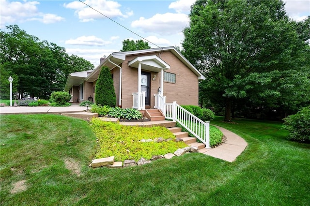 220 N Dr, Center Twp But, PA 16001 - view of front facade featuring a front lawn, a chimney, and brick siding