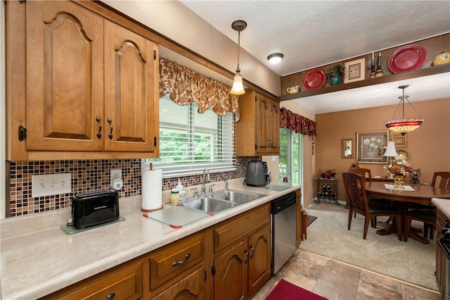 220 N Dr, Center Twp But, PA 16001 - kitchen with stainless steel dishwasher, brown cabinets, light countertops, decorative backsplash, and decorative light fixtures