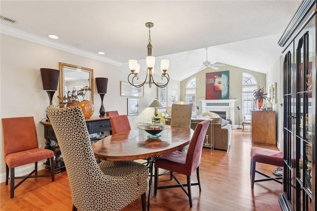 5111 Hemlock, Murrysville, PA 15668 - dining area with light wood finished floors, ceiling fan, a chandelier, a fireplace, and vaulted ceiling