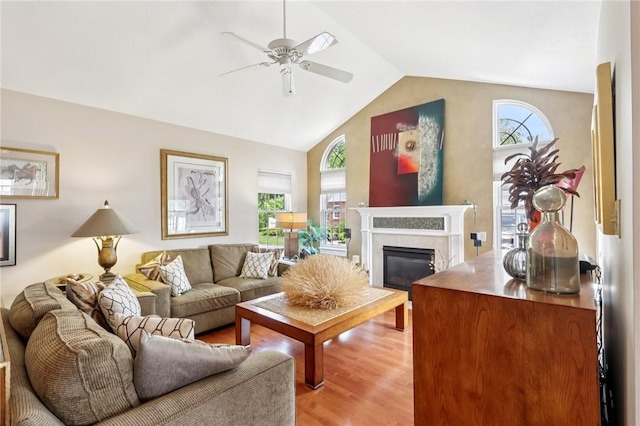 5111 Hemlock, Murrysville, PA 15668 - living room with ceiling fan, light wood-style floors, a glass covered fireplace, and high vaulted ceiling