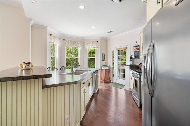 222 Adams Pointe Blvd Unit 1, Adams Twp, PA 16046 - kitchen with stainless steel appliances, cream cabinetry, ornamental molding, dark countertops, and dark wood-style floors