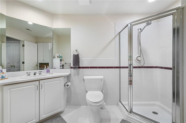 222 Adams Pointe Blvd Unit 1, Adams Twp, PA 16046 - full bathroom with a stall shower, vanity, tile patterned flooring, tile walls, and wainscoting