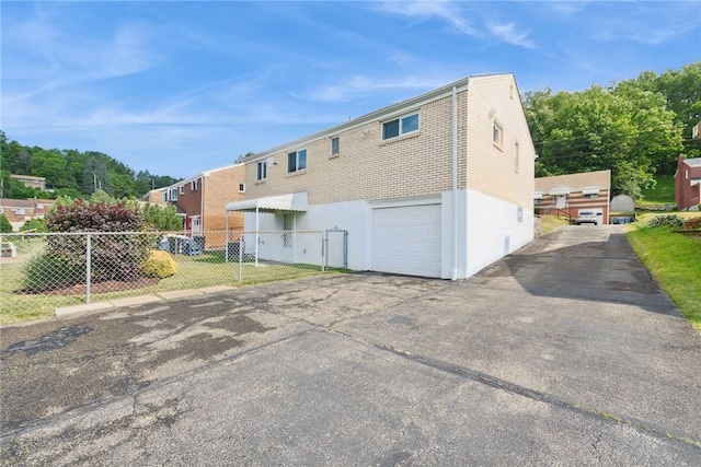991 Diane Dr N, Versailles, PA 15137 - rear view of property featuring an attached garage and driveway