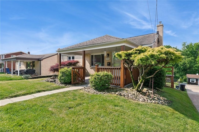 991 Diane Dr N, Versailles, PA 15137 - view of front facade featuring a chimney, a front yard, covered porch, and brick siding
