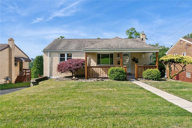 991 Diane Dr N, Versailles, PA 15137 - bungalow-style home with brick siding, covered porch, a front yard, and a chimney