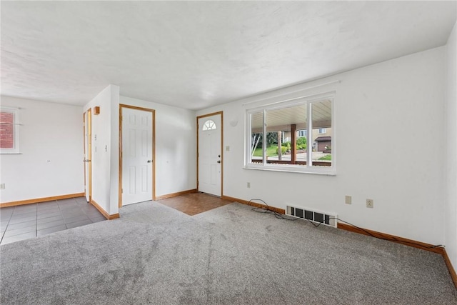 991 Diane Dr N, Versailles, PA 15137 - unfurnished living room featuring plenty of natural light, carpet floors, and tile patterned floors