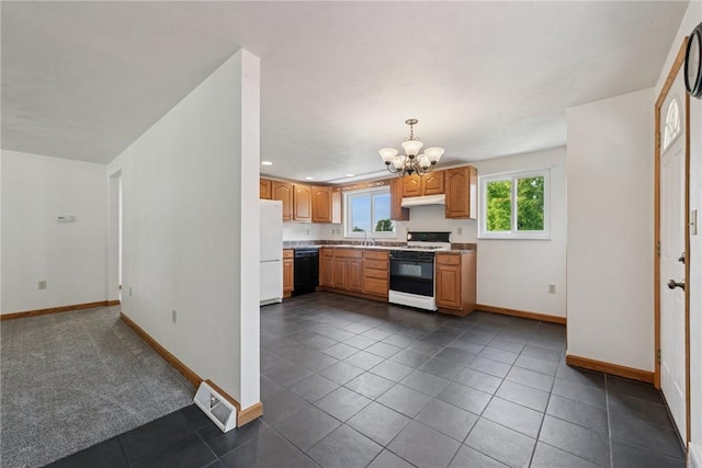991 Diane Dr N, Versailles, PA 15137 - kitchen featuring white appliances, a chandelier, under cabinet range hood, dark tile patterned floors, and light countertops