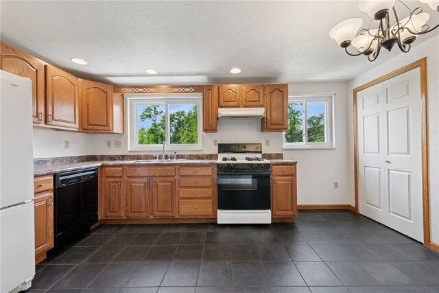 991 Diane Dr N, Versailles, PA 15137 - kitchen with white appliances, under cabinet range hood, a chandelier, dark tile patterned floors, and recessed lighting