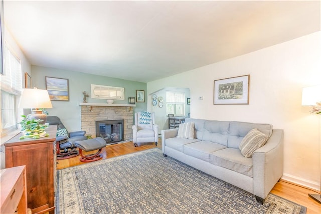 2688 Summit St, Bethel Park, PA 15102 - living room featuring wood finished floors, arched walkways, and a stone fireplace
