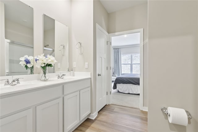 3049 Audrey Dr, Hempfield Twp, PA 15601 - bathroom with double vanity, connected bathroom, and wood finished floors