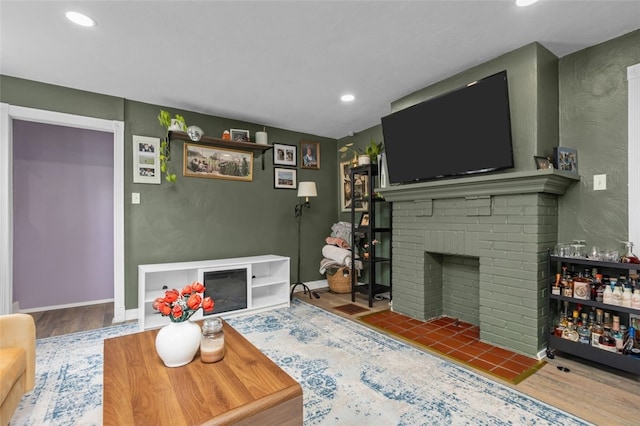 7129 Michigan Ave, Swissvale, PA 15218 - living area featuring a brick fireplace, wood finished floors, and recessed lighting