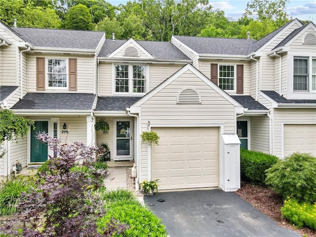 251 Commons Dr, Oakmont, PA 15139 - townhome / multi-family property featuring asphalt driveway, a shingled roof, and a porch