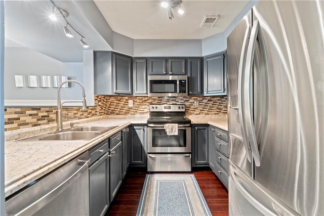 251 Commons Dr, Oakmont, PA 15139 - kitchen featuring stainless steel appliances, gray cabinets, dark wood finished floors, track lighting, and light countertops