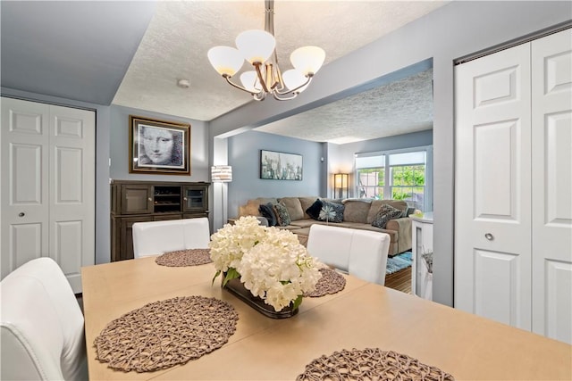 251 Commons Dr, Oakmont, PA 15139 - dining room featuring a textured ceiling and a chandelier