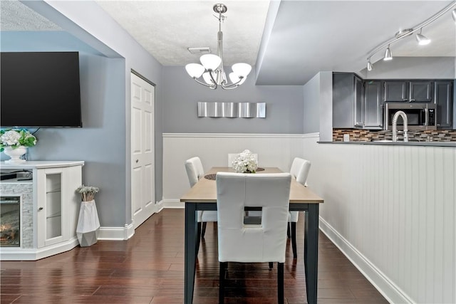 251 Commons Dr, Oakmont, PA 15139 - dining room with a wainscoted wall, dark wood finished floors, and a chandelier