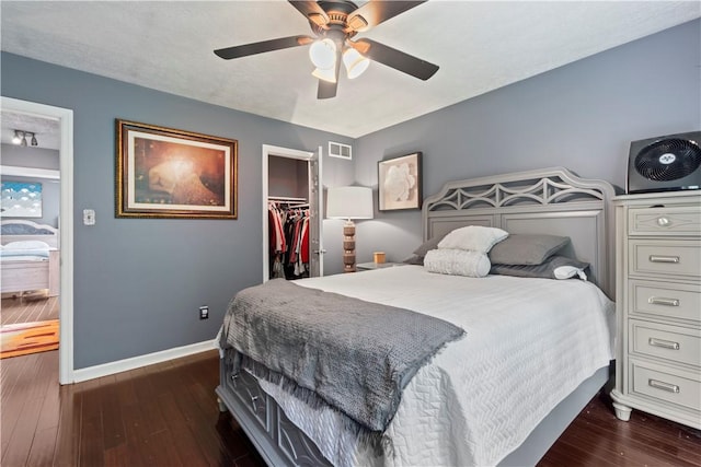 251 Commons Dr, Oakmont, PA 15139 - bedroom with dark wood finished floors, a closet, a walk in closet, and ceiling fan