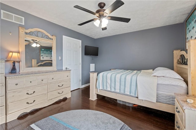 251 Commons Dr, Oakmont, PA 15139 - bedroom featuring dark wood-style floors, a textured ceiling, and ceiling fan