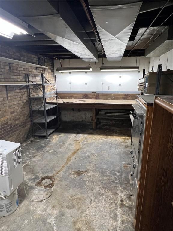 384 E End Ave, Beaver, PA 15009 - unfinished below grade area with a workshop area and brick wall