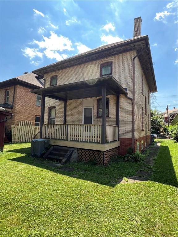 384 E End Ave, Beaver, PA 15009 - rear view of house with a porch, brick siding, and a chimney