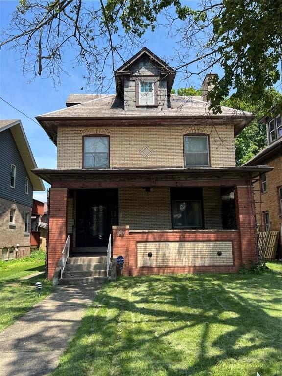 384 E End Ave, Beaver, PA 15009 - american foursquare style home featuring brick siding, a porch, a front yard, and a chimney