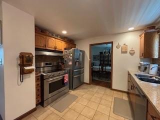 2355 School St, Mount Pleasant Twp Wml, PA 15666 - kitchen featuring stainless steel appliances, under cabinet range hood, recessed lighting, brown cabinetry, and light tile patterned floors