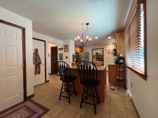 2355 School St, Mount Pleasant Twp Wml, PA 15666 - dining area with light tile patterned floors and a chandelier