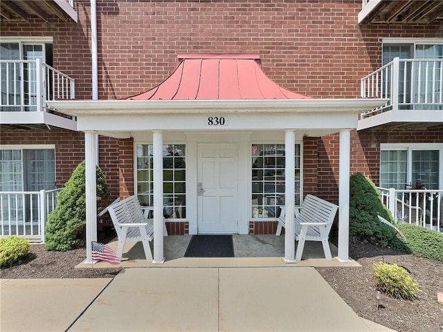 830 S Main St Unit 206, City Of Washington, PA 15301 - doorway to property with a standing seam roof, brick siding, and a metal roof