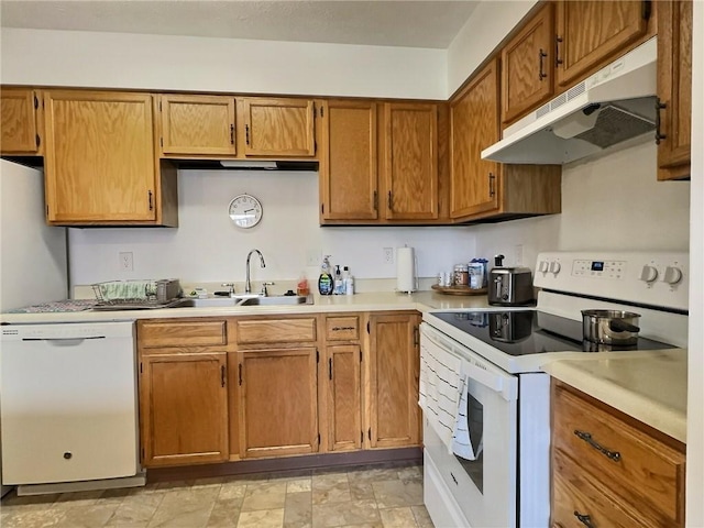 830 S Main St Unit 206, City Of Washington, PA 15301 - kitchen featuring white appliances, under cabinet range hood, light countertops, and brown cabinets