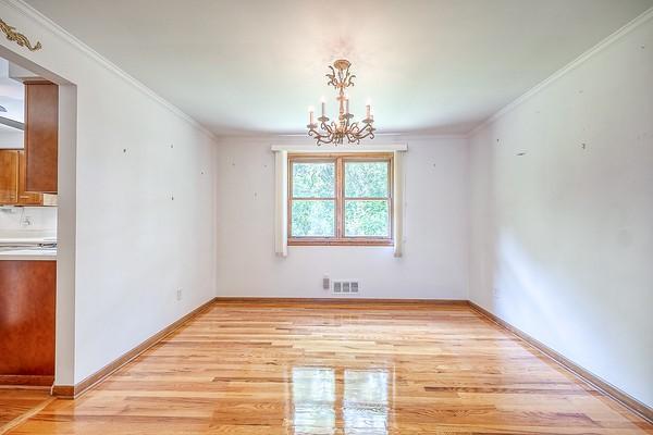 4517 W Brightview Ave, Whitehall, PA 15227 - unfurnished dining area featuring light wood-type flooring, a chandelier, and ornamental molding