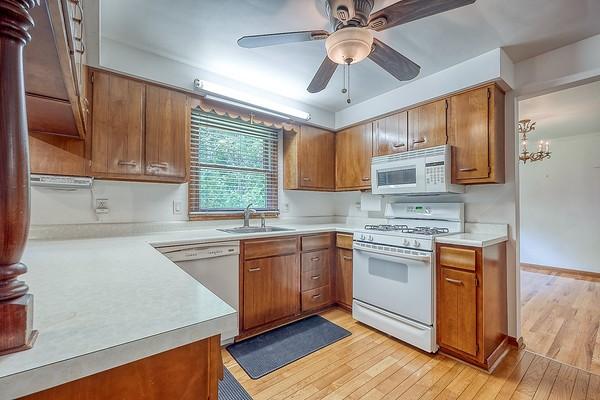 4517 W Brightview Ave, Whitehall, PA 15227 - kitchen with white appliances, brown cabinets, light countertops, and light wood-style flooring
