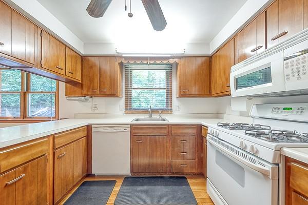 4517 W Brightview Ave, Whitehall, PA 15227 - kitchen featuring white appliances, a ceiling fan, light countertops, brown cabinetry, and light wood-style floors