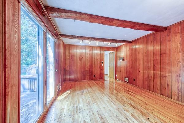 4517 W Brightview Ave, Whitehall, PA 15227 - spare room featuring beamed ceiling, light wood-style flooring, and wood walls