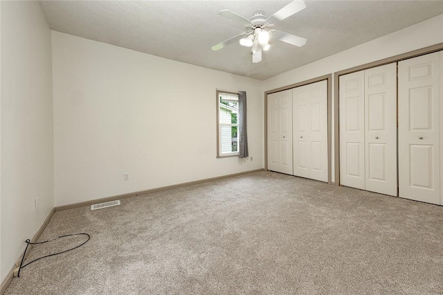 407 Hill St, Grove City Boro, PA 16127 - unfurnished bedroom featuring multiple closets, carpet floors, and a ceiling fan