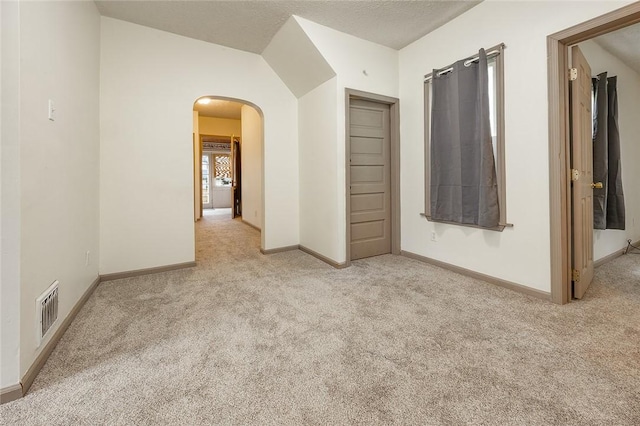 407 Hill St, Grove City Boro, PA 16127 - carpeted empty room featuring arched walkways and vaulted ceiling