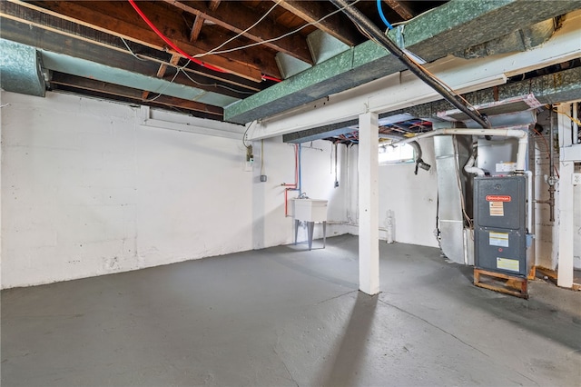 404 Ariston Ave, Carrick, PA 15210 - unfinished basement featuring a sink and heating unit